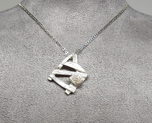 Abstract 'gate' with clear navette cubic zirconia pendant