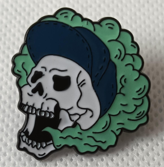 Enamel White Skull With Teal Smoke Pin Badge.