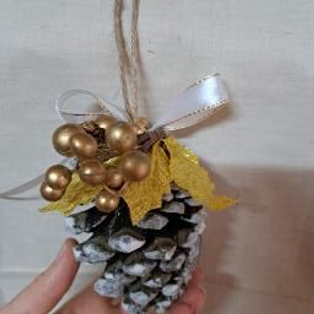 Pomme de pin enneigée et houx doré