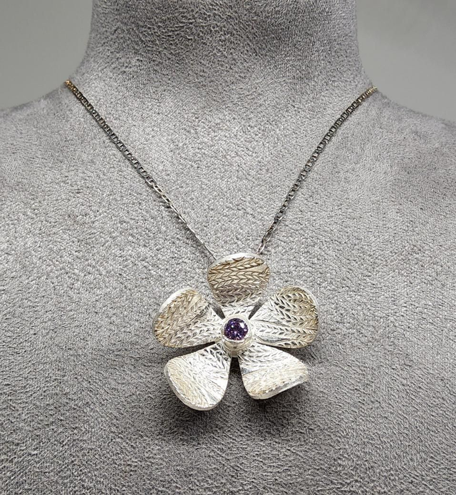 Wheat design textured flower pendant with lilac cubic zirconia on silver necklace