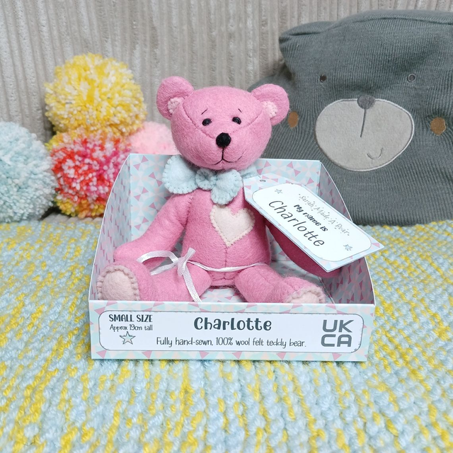 Charlotte. Small size, handmade teddy bear. UKCA. Tray base packaging. Standard Wool Felt. Cherry blossom pink. Spearmint. Blush. Baby Pink. 