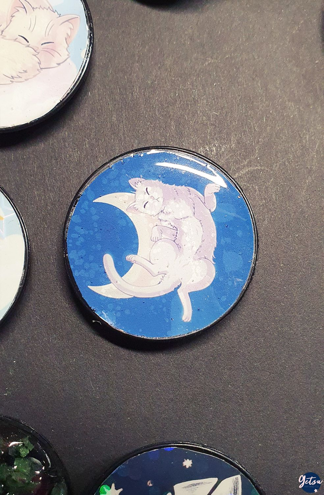 Poignée de téléphone chat dormant sur un croissant de lune