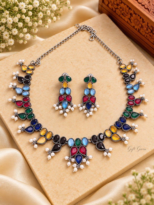 Multicolor oxidised silver necklace and matching earring set adorned with teardrop-shaped stones and small white seed beads