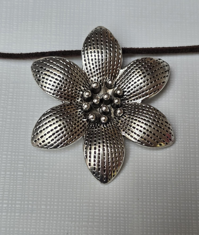 Necklace with a large silver flower pendant