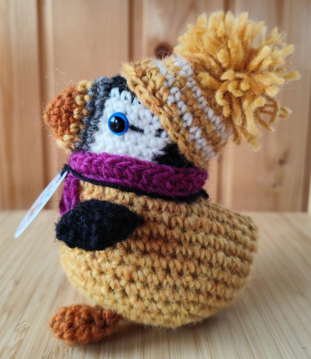 Ginger the puffin wearing mimosa yellow sweater, scarve and hat (made from Icelandic wool yarn)