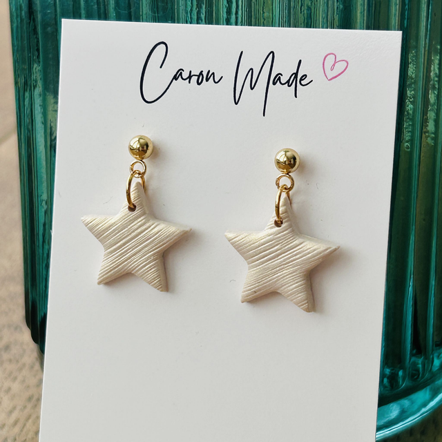 Small light gold beige star earrings
