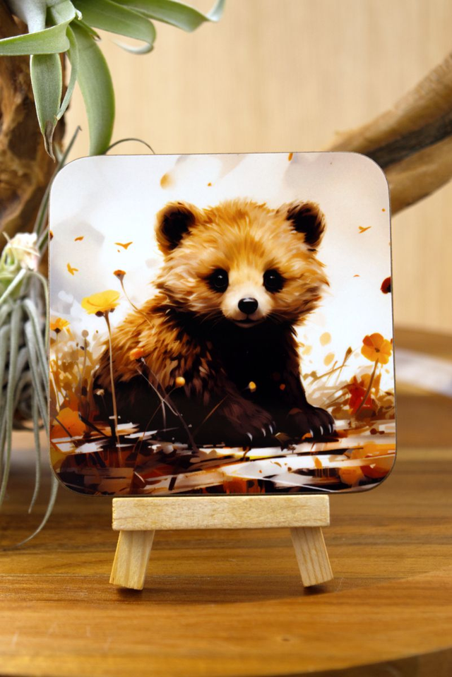 Square Coaster: Adorable Bear Cub Nestled in Lush Foliage Design
