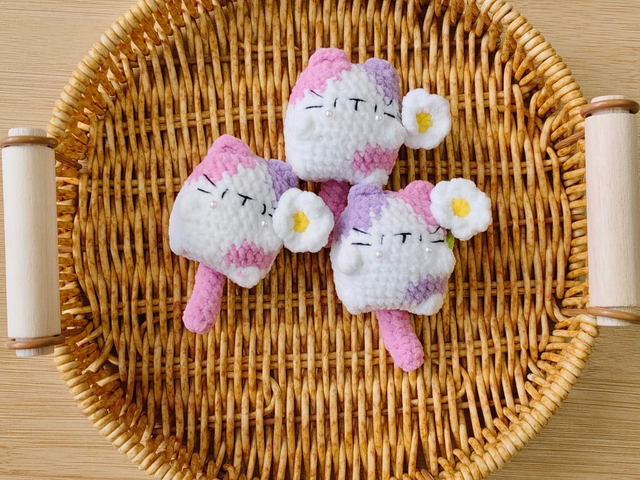 pink cute cat with flowers on hand