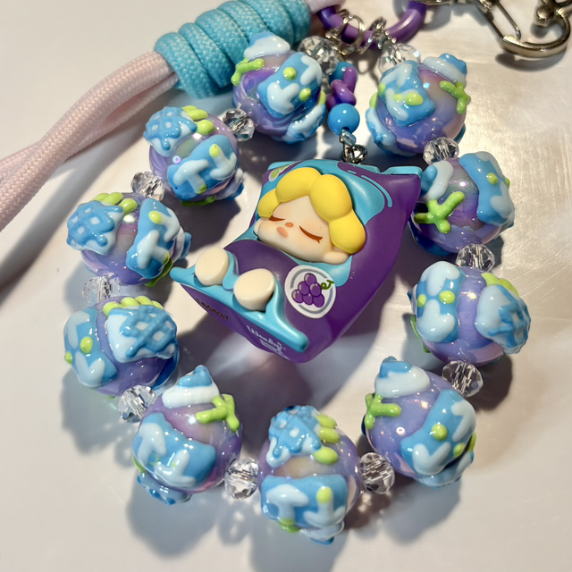 Beautiful handpainted beaded keychain with authentic doll figure in turquoise/purple design 