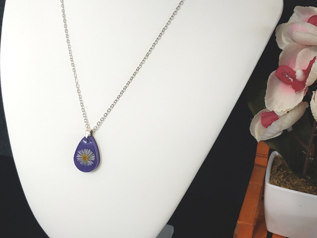 Collier fleur de pâquerette sur fond violet