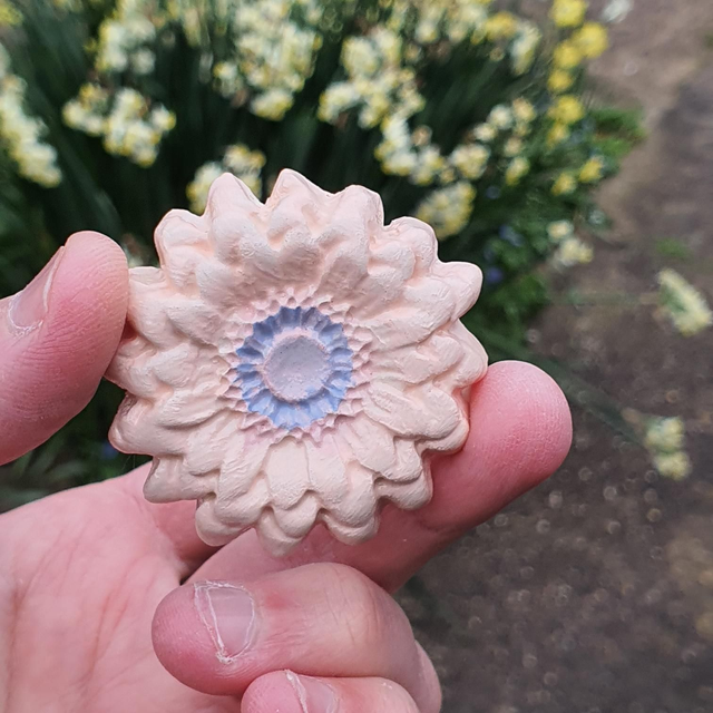 Orange many petal flower badge 