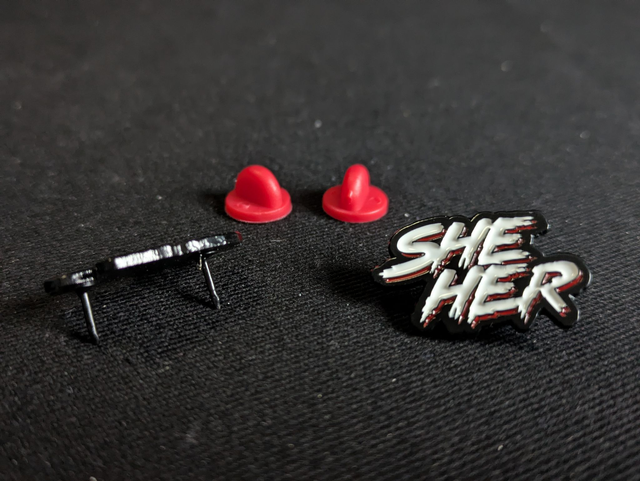 John Carpenter's "They Live" Inspired She/Her Pronoun Pin Badge