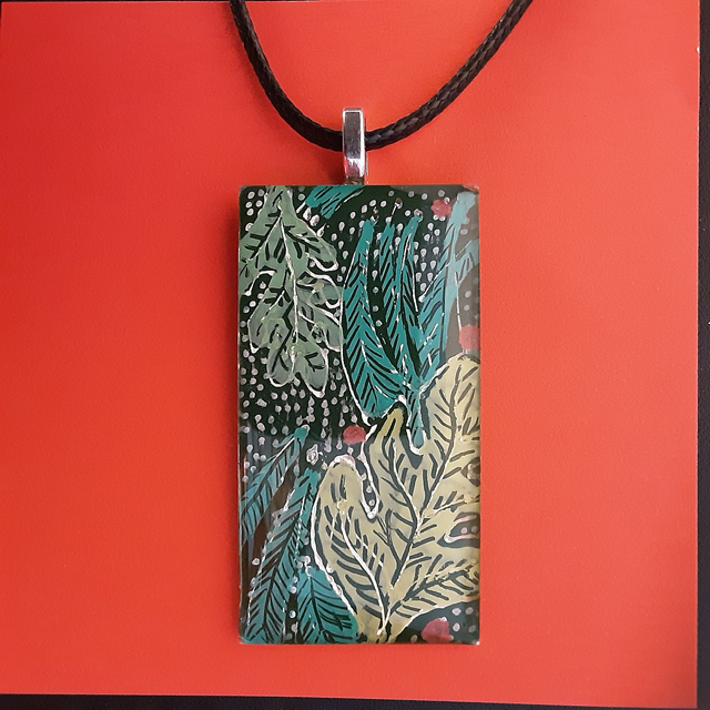 Pendentif collection élégance fond noir et motifs feuilles délicates