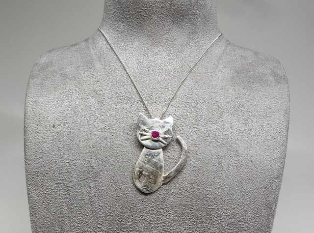 Cat pendant with fuchsia cubic zirconia on silver necklace