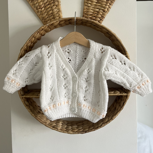 Peach ribbon, white cardi 