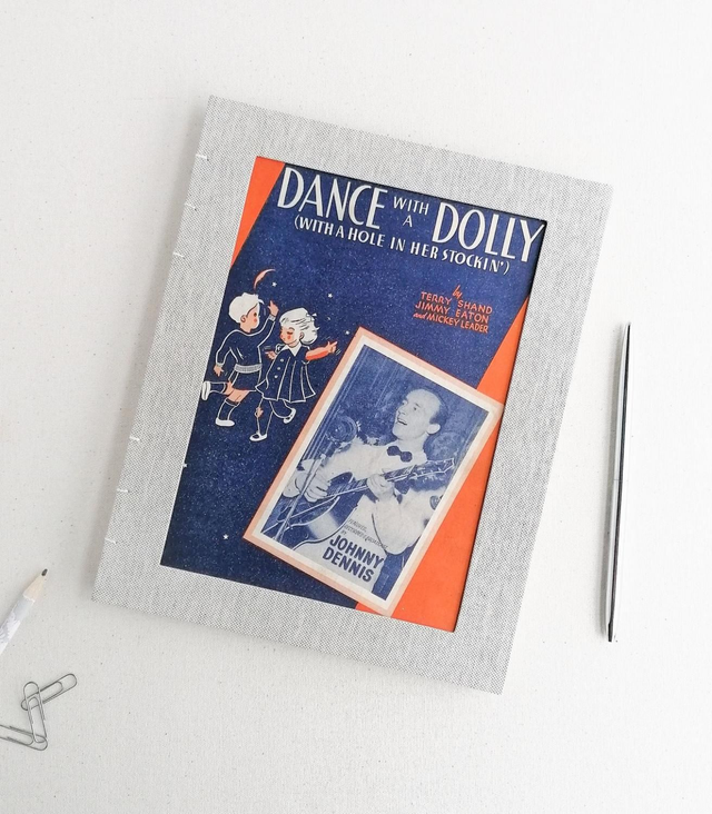 'Dance with a Dolly' Medium size grey stitched portrait Notebook with plain paper.