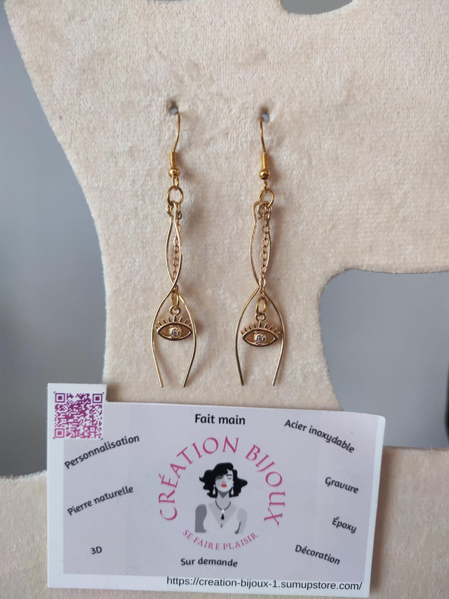 Boucle d'oreille pendante  avec yeux 