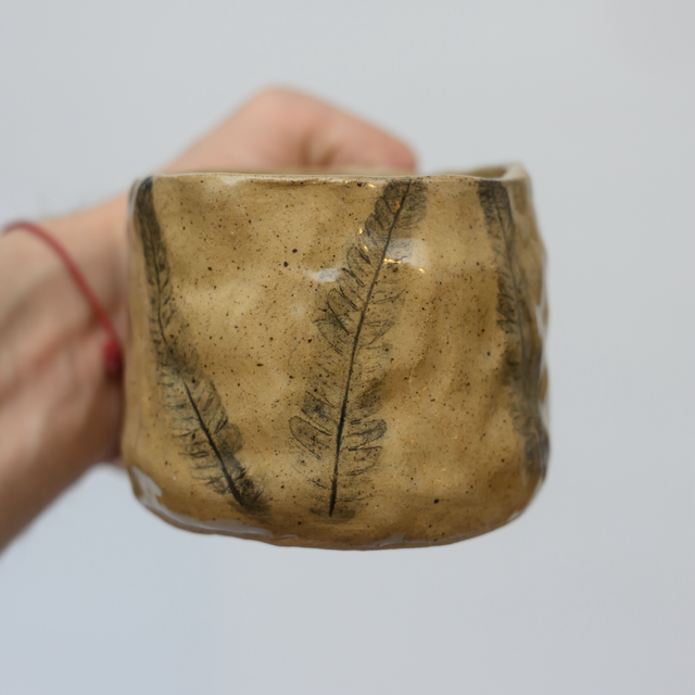 Small leaves pressed in mug 