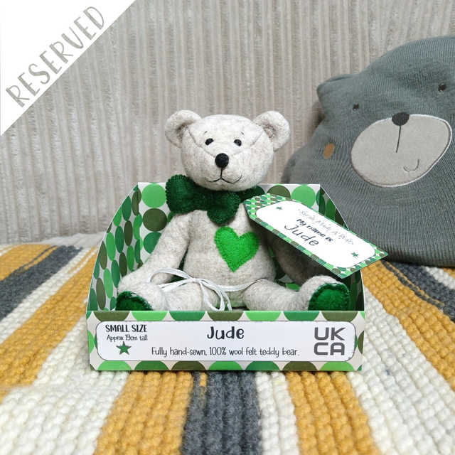 Jude. Small size, handmade teddy bear. UKCA. Tray base packaging. Standard Wool Felt. Beige. Green.