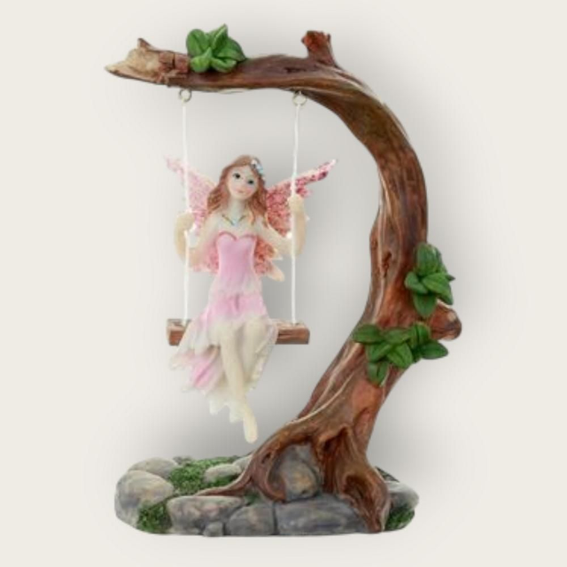 Fée rose sur balançoire