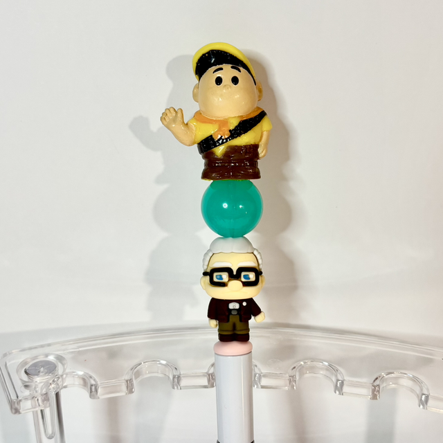 'UP' character figures beaded pen