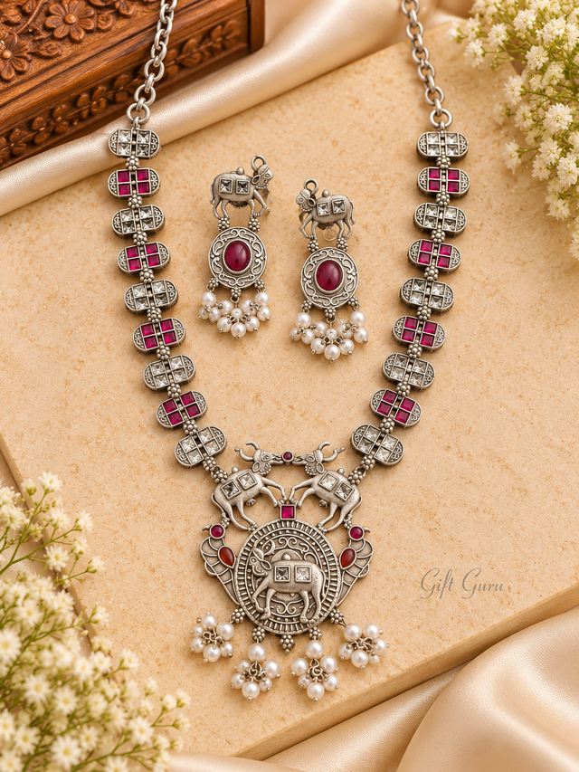 Oxidized silver necklace traditional Indian Kamdhenu (cow) motifs with pink ruby pearl bead hangings.