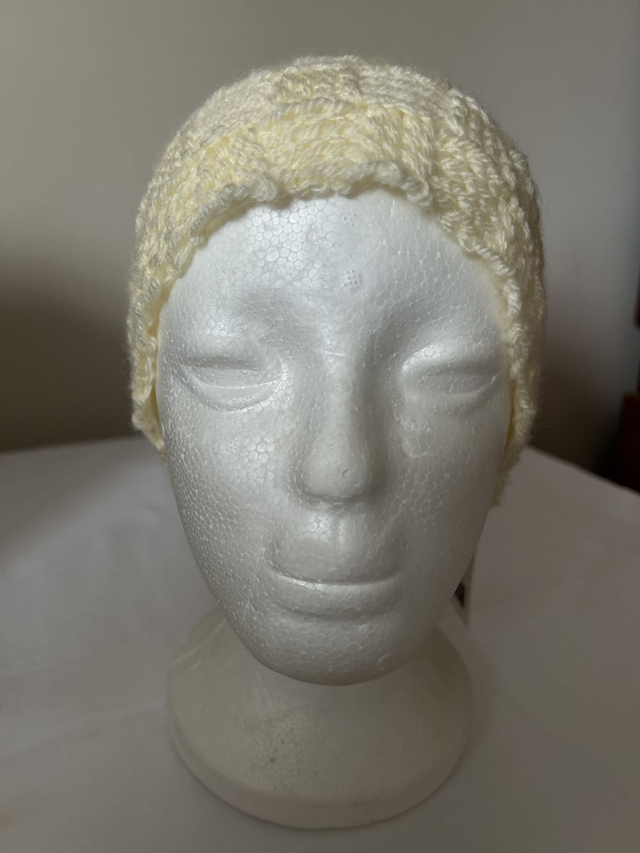 7067. Ladies knitted ear warmers, cream