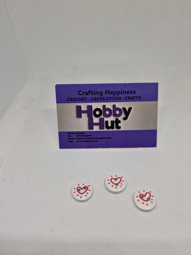 White Buttons With One Red Outlined Heart