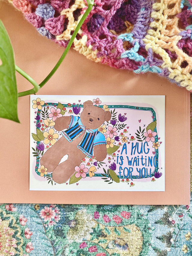 'A hug is waiting' postcard