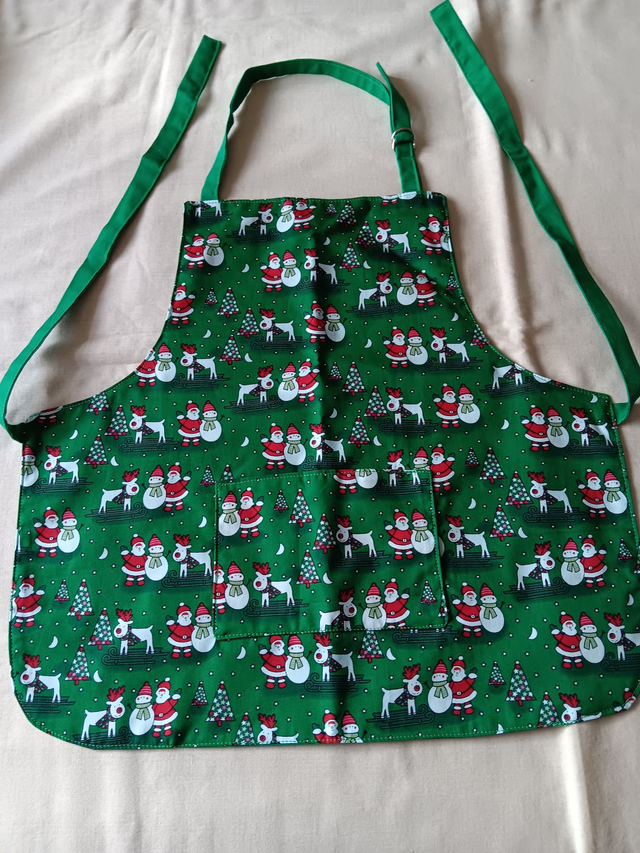 Childs Kitchen Play Apron Green Seasonal Print Cotton Fabric with Front pocket and Green lining, waist ties and adjustable neck ties 