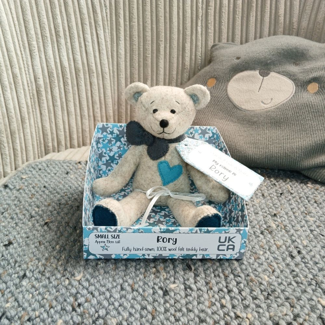 Rory. Small size, handmade teddy bear. UKCA. Tray base packaging. Standard Wool Felt. Beige. Blue. Teal. Grey.