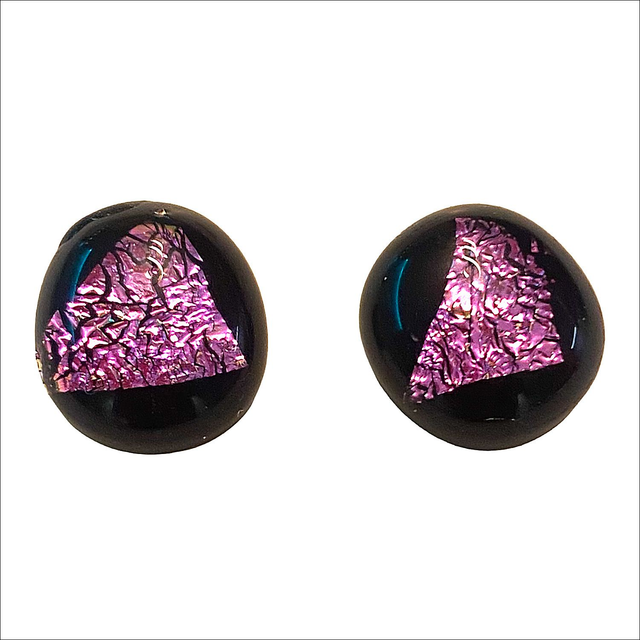 Stud earrings with dichroic pink on a black background fused glass