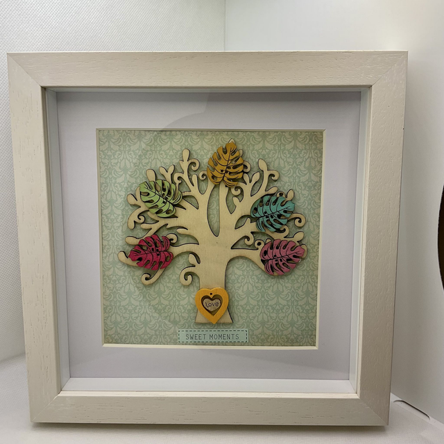 Wooden tree frame with colourful wooden leaves. Sweet moments quote.