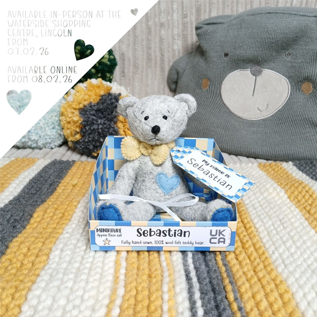 Sebastian. Miniature size, handmade teddy bear. UKCA. Tray base packaging. Standard Wool Felt. Grey. Yellow. Blue. 