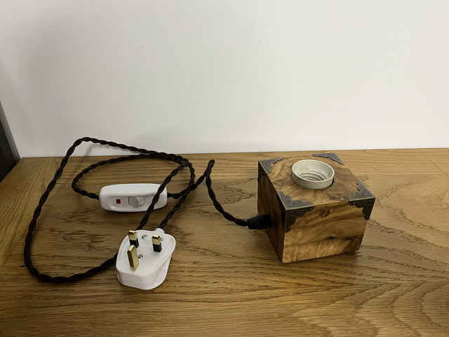 Rustic bedside lamp made of olive wood.