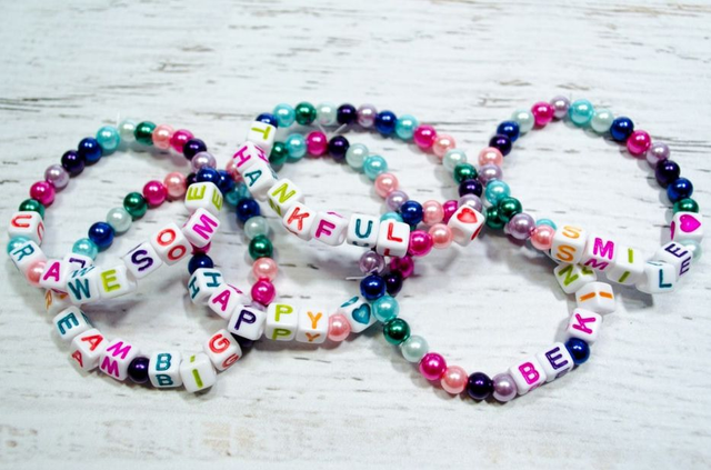 Bracelet making (many colours, letters, threads) per child