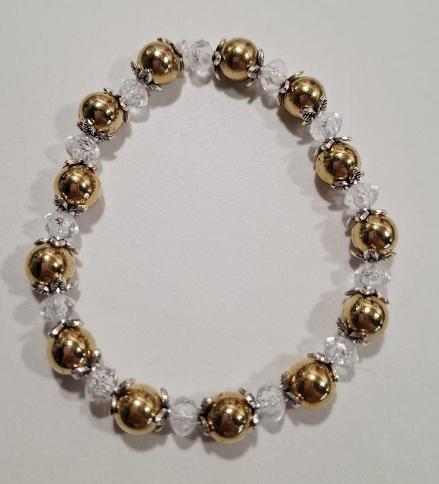 Gold beaded bracelet with silver flower detail