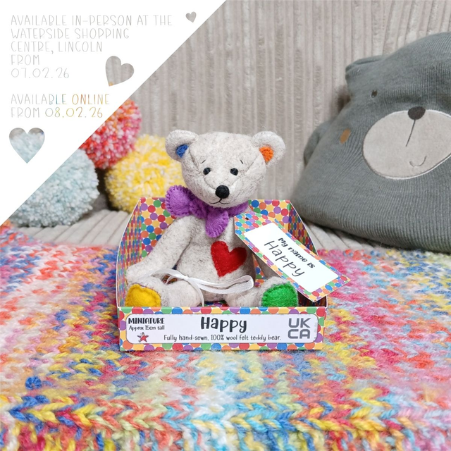 Happy. Miniature size, handmade teddy bear. UKCA. Tray base packaging. Standard Wool Felt. Beige. Yellow. Blue. Green. Orange. Purple. Red.