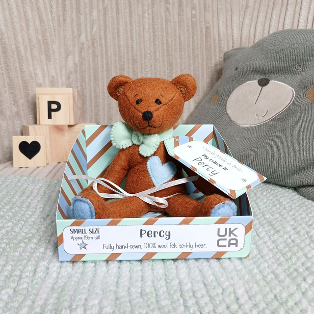 Percy. Small size, handmade teddy bear. UKCA. Tray base packaging. Standard Wool Felt. Gingerbread brown. Pastel green. Baby blue. Sky blue.