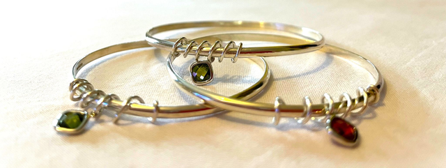 Twinkle and Twist: Recycled Silver Bangle – Garnet or Peridot Cubic Zirconia Charm