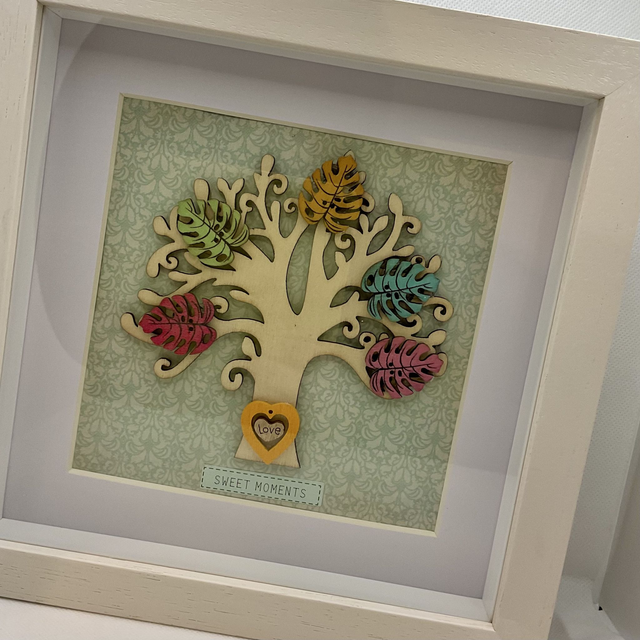 Wooden tree frame with colourful wooden leaves. Sweet moments quote.
