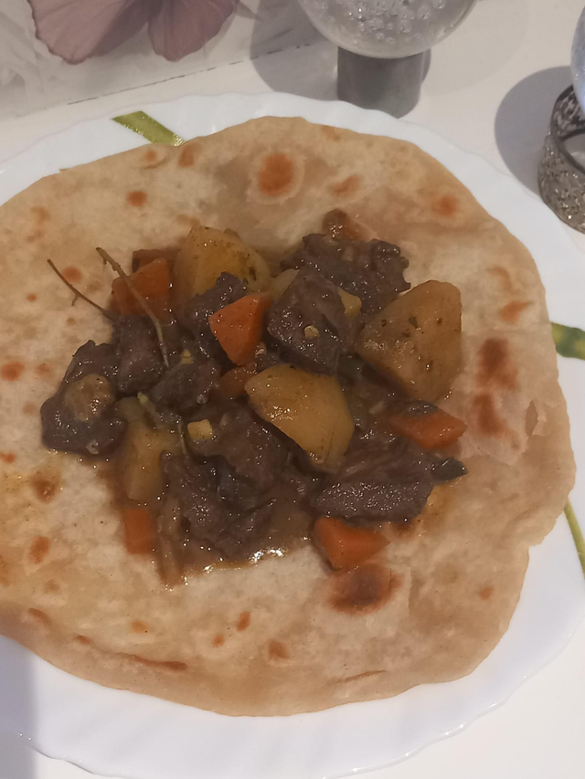 Sizzling Curry Goat Roti 