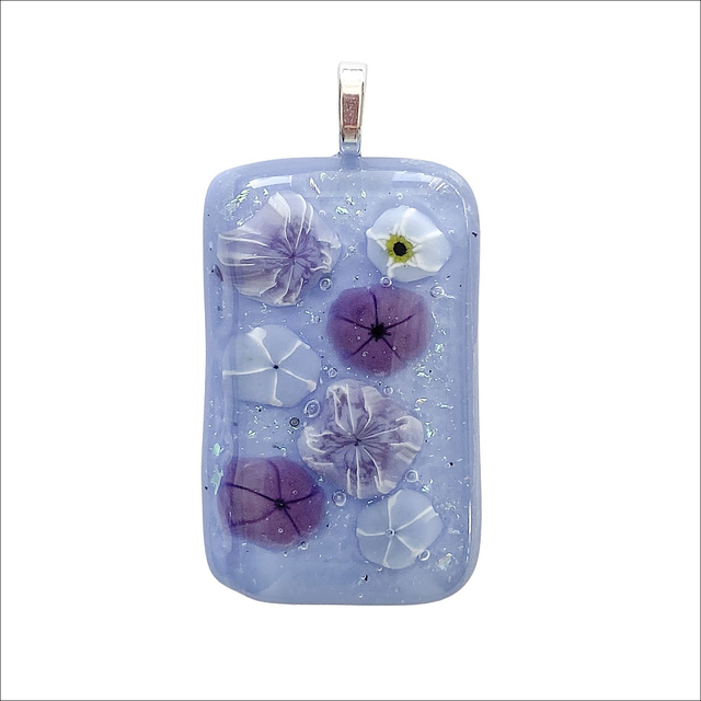 Pendant with pale sky blue background, pale blue and purple flowers with sparkly dichroic dust (Ref P34)