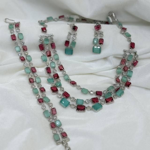 Multi-layered, silver-toned necklace with matching earrings and a bracelet.