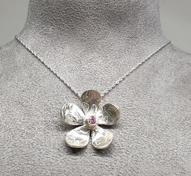 Swirl flower pendant with pink cubic zrconia on silver necklace
