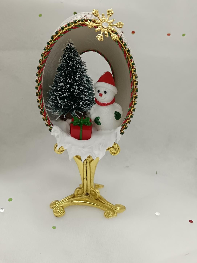 Snowman on a gold stand in a Duck egg.