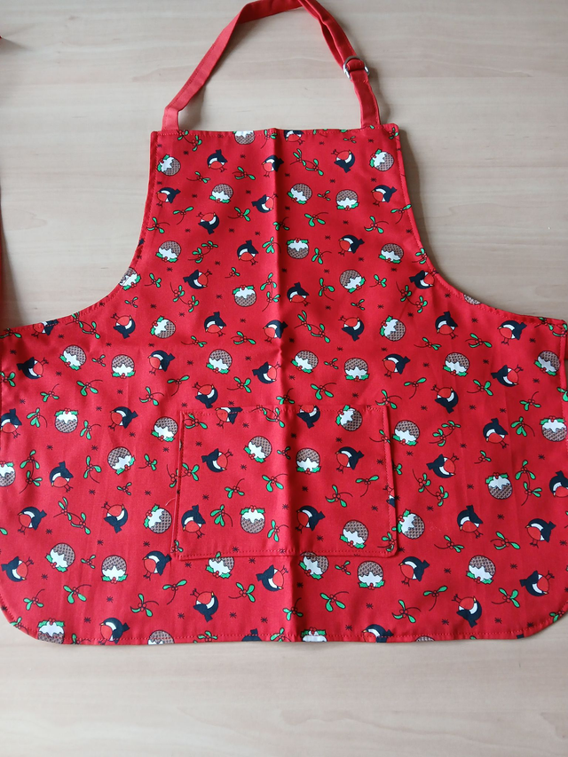 Childs Kitchen Play Apron Pudding Patterned Cotton Fabric with Front pocket and Red lining, waist ties and adjustable neck ties (1)