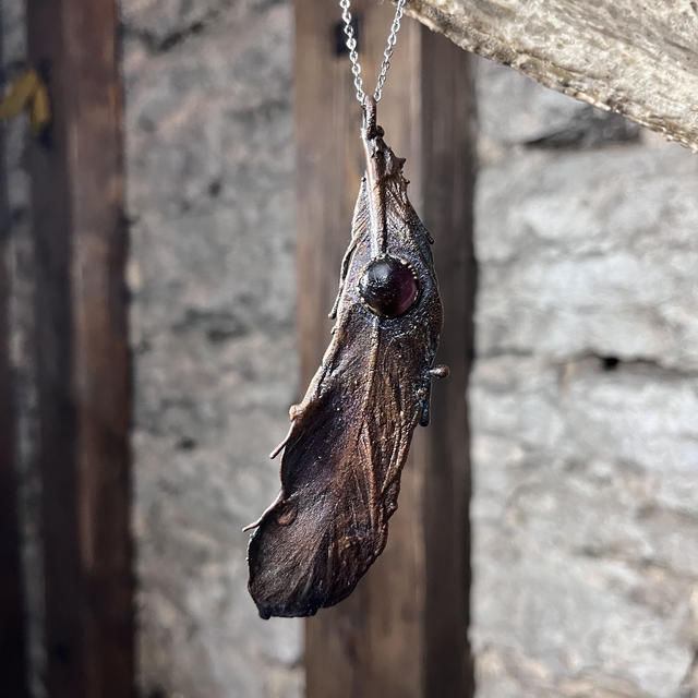 Real chicken feather with amethyst cabochon
