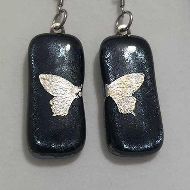 Black fused glass dangly earrings with silver butterfly design e84