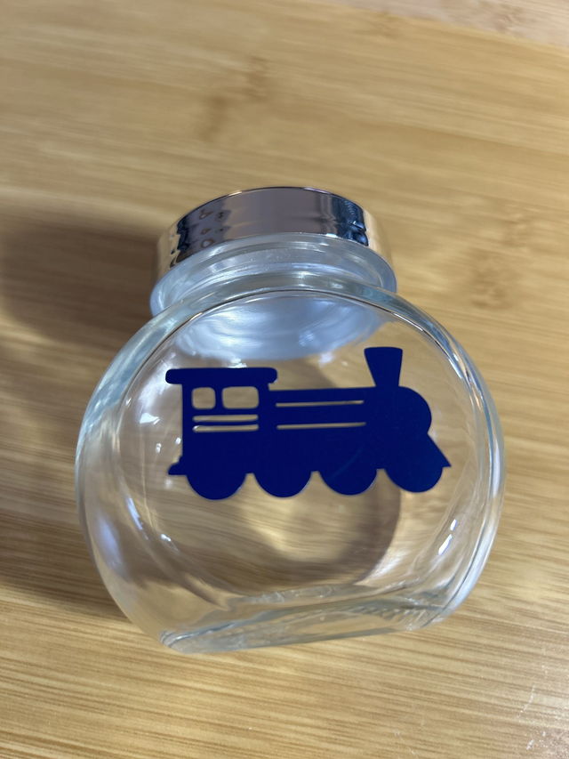 N9. Empty train sweet jar.